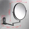 A black metal wall-mounted magnifying mirror with dimensions indicated by red lines and text. Produktbild-Vorschau