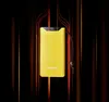 A yellow power bank with a digital display showing '90%' is presented against a dark background with vertical orange and red light streaks. Voir les images du produit