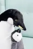 A close-up of two plush penguins, one larger and one smaller, nestled together. Podgląd zdjęcia produktu
