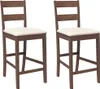 Two brown bar stools with cream cushions are shown against a white background.
