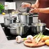 A person is cooking with a set of pots on a stovetop, with vegetables and ingredients in the foreground. Náhled obrázku produktu