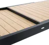 A close-up view of a section of a table with a wooden top and a black frame. Produktbild-Vorschau