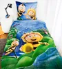 A bed with a duvet cover and pillow featuring cartoon bees. Produktbild-Vorschau