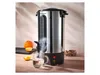 A hot beverage dispenser is shown on a wooden table, with steam rising from the tap into a glass mug. Oranges and sugar cubes are nearby. Produktbild-Vorschau