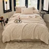 A cozy bedroom scene with a bed made up with a thick, textured beige blanket and pillows. Anteprima dell’immagine prodotto