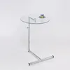 A modern glass and chrome side table with a cup on it. Produktbild-Vorschau