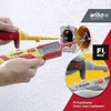 A person is using a Wiha voltage tester to check electrical wiring in a wall socket. Náhľad obrázku produktu