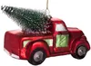 A red glass Christmas ornament shaped like a vintage pickup truck carrying a small green Christmas tree. Voir les images du produit