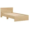A light brown wooden bed frame with a headboard, shown from a side angle against a white background. Produktbild-Vorschau
