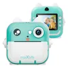 A teal and white instant print camera with a cute cartoon face design, shown from the front and back. The back view displays a screen showing two children smiling. Náhľad obrázku produktu
