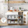 A white kitchen island with a wooden countertop is shown in a kitchen setting, with its doors open to reveal storage compartments. Produktbild-Vorschau
