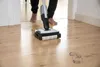 A person is mopping a wooden floor with a cleaning device. Anteprima dell’immagine prodotto