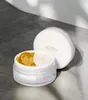 A white jar of d'Alba White Truffle Double Serum & Cream is open, revealing its dual-textured contents. The lid is placed behind the jar. Anteprima dell’immagine prodotto