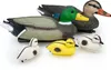 A set of plastic duck decoys, including adult mallards and ducklings, arranged on a white background. Produktbild-Vorschau