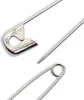 Close-up view of parts of two safety pins against a white background. Produktbild-Vorschau