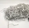 A tangled pile of LED string lights on a white surface. Produktbild-Vorschau