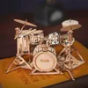 A miniature wooden drum set is displayed on a surface. Náhľad obrázku produktu