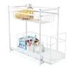 A white two-tier sliding drawer organizer for under a sink or in a cabinet, filled with bathroom/kitchen items. Produktbild-Vorschau