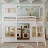 A white loft bed with natural wood accents, featuring a play kitchen and laundry area underneath, set in a child's room. Anteprima dell’immagine prodotto