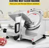 A commercial electric meat slicer is displayed on a kitchen counter, with raw meat and onions in the foreground. Produktbild-Vorschau
