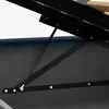 A close-up view of the internal mechanism of a bed frame, showing a gas spring and metal support structure. Náhľad obrázku produktu