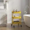 A bathroom scene with a yellow rolling cart filled with toiletries and towels next to a bathtub. Voir les images du produit
