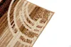 A close-up view of a rug with a modern abstract pattern. Produktbild-Vorschau