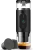 A black portable electric espresso machine is shown with coffee capsules and a freshly brewed espresso. Podgląd zdjęcia produktu