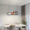 A dining room with a table and chairs, featuring a hanging wine rack with bottles and glasses. Podgląd zdjęcia produktu