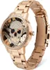 A rose gold watch with a skull design on the face, set against a white background. Produktbild-Vorschau