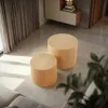 Two wooden cylindrical tables are placed on a tiled floor in a modern living room setting, with curtains visible in the background. Voir les images du produit