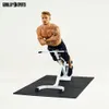 A man is performing a hyperextension exercise on a white fitness machine against a white background. Produktbild-Vorschau