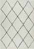 A close-up, top-down view of a shaggy rug with a diamond pattern. Produktbild-Vorschau