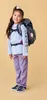 A young girl wearing a backpack and school uniform, posing against a plain background. Náhľad obrázku produktu