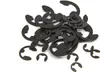 A pile of black E-clips or circlips on a white background. Produktbild-Vorschau