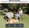 A woman reads a book in a garden while a golden retriever lies on the grass nearby. A small table with a tablecloth and some items is set up between them. Produktbild-Vorschau