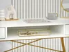 A white desk with gold accents, featuring decorative items and a cup of coffee. Voir les images du produit