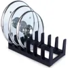 A black pot lid organizer holding three glass pot lids. Produktbild-Vorschau