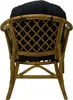 The back view of a rattan chair with black cushions. Anteprima dell’immagine prodotto