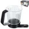 A digital kitchen scale with a measuring cup attachment, placed on a white background. A box with product information is shown in the upper right corner. Náhľad obrázku produktu