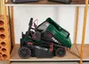 A folded electric lawnmower is stored on a shelf in a storage area. Produktbild-Vorschau