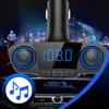A car FM transmitter with a digital display showing '108.0' and music notes icon, set against a blurred background of a band performing on stage. Anteprima dell’immagine prodotto