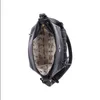 A black handbag is shown from a top-down perspective, with its interior lining visible. Náhled obrázku produktu