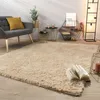 A cozy living room scene with a plush rug, armchair, and decorative items. Produktbild-Vorschau