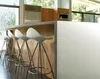 A modern kitchen with a white island and bar stools. Podgląd zdjęcia produktu