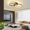 A modern living room with a stylish ceiling light, a large TV, and a comfortable sofa. Voir les images du produit