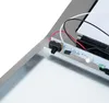 A close-up view of the internal components of a solar-powered house number, showing a circuit board with a switch and LED light. Podgląd zdjęcia produktu