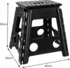 A black folding stool with dimensions indicated by measurement lines. Náhled obrázku produktu