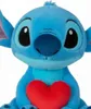 A close-up shot of a blue Stitch plush toy holding a red heart. Podgląd zdjęcia produktu
