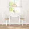 A white dining table with two white chairs with brown cushions, set in front of a window with blinds. Náhled obrázku produktu